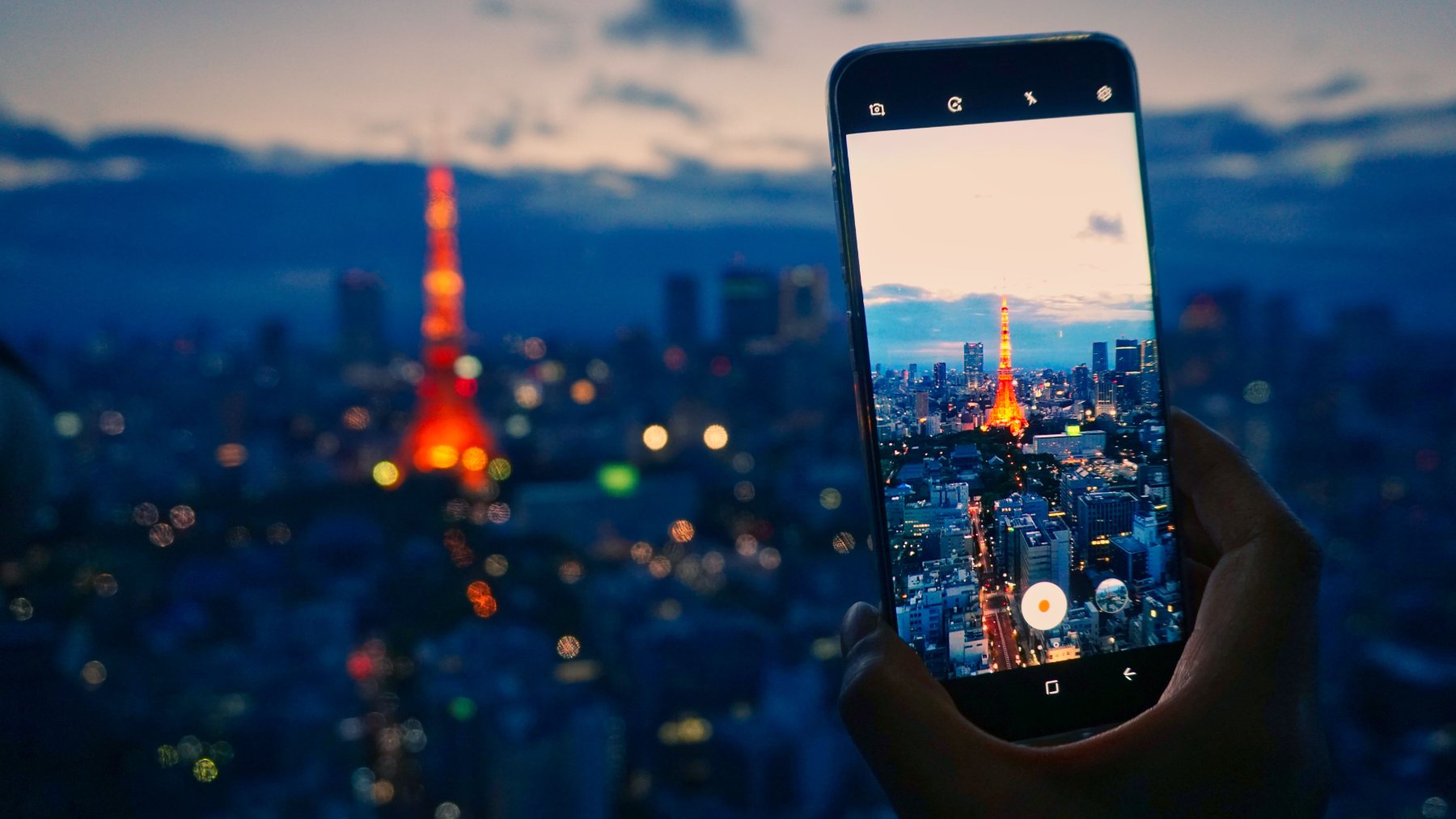 Using a phone to take a picture of Tokyo Tower